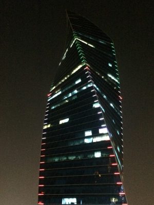 Kuwait twisting skyscraper at night with coloured lighting