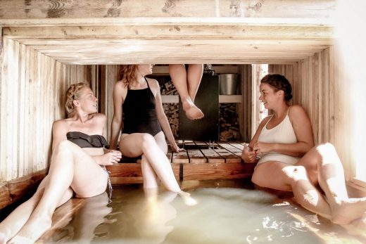 Floating wilderness sauna bathing students in Soomaa