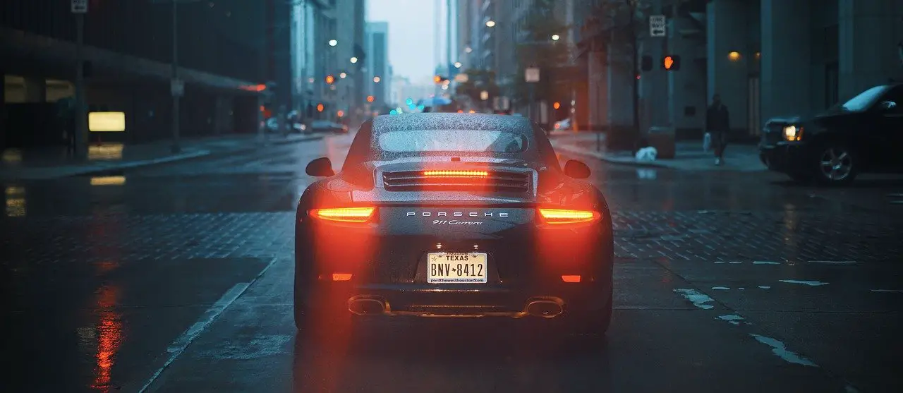 Car Tail Lights Porsche 911 vehicle in rain city