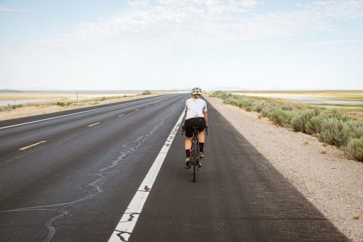 Seal coating of asphalt pavements cyclist on road path