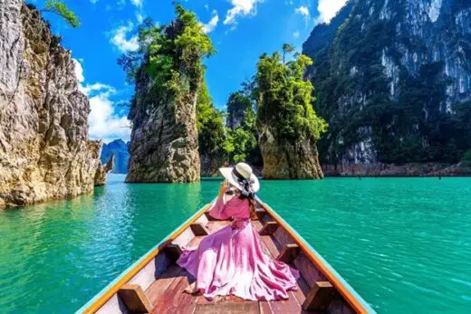 Woman on a boat with islands in southeast Asia