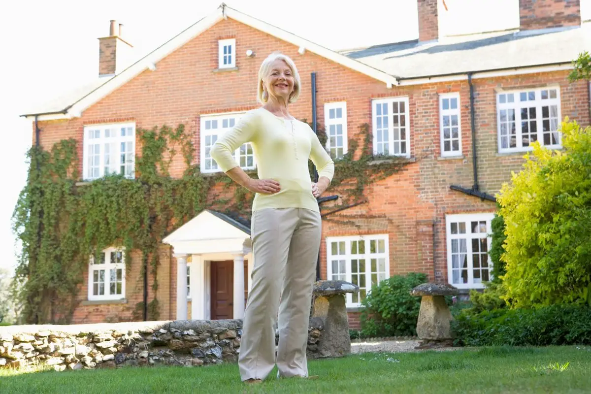 Woman on her lawn at home - about the buy and hold real estate investors