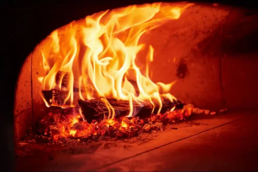 logs of wood burning in an oven