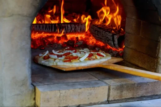 putting pizza in the oven at home