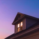House siding site installation dormer at dusk