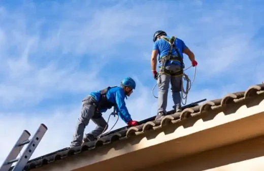 Home roof contractor workers ridge tiles